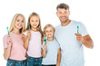 © LIGHTFIELD STUDIOS - happy parents and kids holding toothbrushes isolated on white
