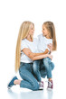 © LIGHTFIELD STUDIOS - happy mother and daughter hugging and looking at each other on white