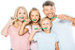© LIGHTFIELD STUDIOS - happy parents and children holding toothbrushes while brushing teeth isolated on white