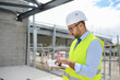 © W PRODUCTION - portrait of handsome foreman construction worker on a industrial building industry construction site