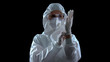 © motortion - Person in protective suit wearing rubber gloves against dark background, toxins