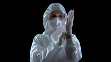 Person In Protective Suit Wearing Rubber Gloves Against Dark Background, Toxins