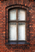 Tightly Closed Vintage Vertical Wooden Window In Red Brick Wall As Fragment Of Old Living House Front View Closeup