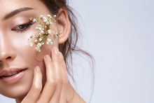 Gorgeous Woman Close-up With Green Plants Under Plaster On Her Cheek
