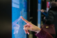 Navigation, Journey, Sci-fi, Technology Concept. Woman Hand Using Touchscreen Display Of Kiosk With City Street Map App At Public Transport Station - Close Up View Of Female Finger Touching Screen