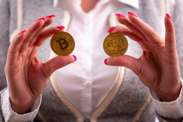 Bitcoin coins in woman's hands