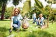 © Viktoriia - Volunteering. Young people volunteers outdoors girl close-up picking litter concentrated