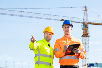 Wall Mural - Two Male Architects Working On Construction Site