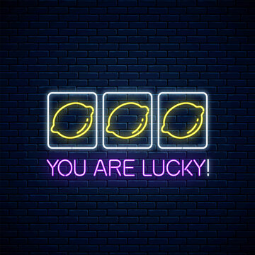 You are lucky - glowing neon motivation phrase with three lemons on slot machine. Slot machine win combination