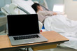 © pushish images - Computer notebook PC and patient in hospital ward
