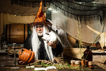 Bearded man dressed like Halloween monster. Portrait of Devil with Halloween bloody make up showing his emotions. Devil vampire man. Happy Halloween.