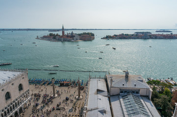 Venice cityscape with island and St Maggiore church and people on St Mark Square