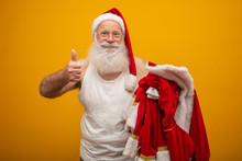 Santa Holding His Clothes After Or Before Delivering Presents. Santa's Clothes. Costume. Thumb Up.