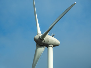 Detail of wind turbine. Close-up to the generator and base of the wind turbines. Renewable energy. Electrical windmills. France countryside