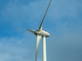 Detail of wind turbine. Close-up to the generator and base of the wind turbines. Renewable energy. Electrical windmills. France countryside