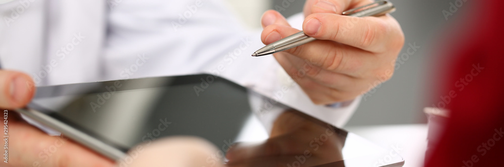 Male doctor hands hold and show digital tablet pc to patient explaining ...