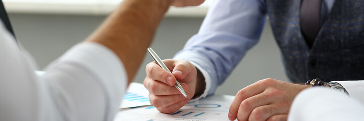 Two clerk businessmen with silver pen in arms deliberate on problem at office workplace closeup. Financial advisor specialist colleague coworking audit cooperation concept