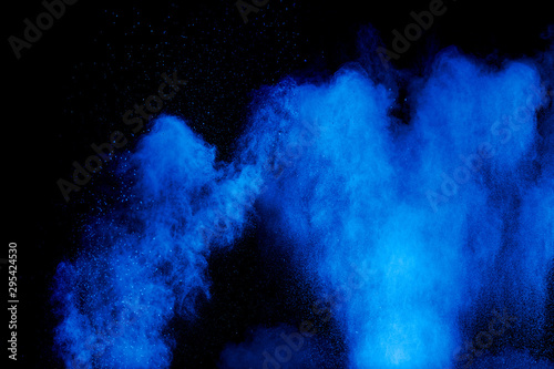 Blue color dust particles splash cloud on black background.Color powder explo...