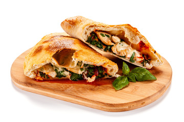 Pizza calzone on cutting board on white background