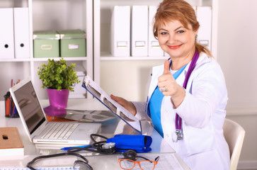 Wall Mural - Female doctor at the desk in the office