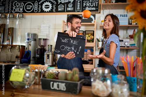 Cuadros en Lienzo Business owner holding Open Sign
