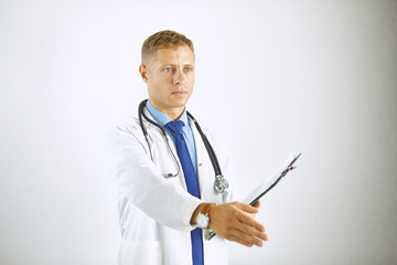 Wall Mural - Young doctor in white coat with a stethoscope greets holding ou