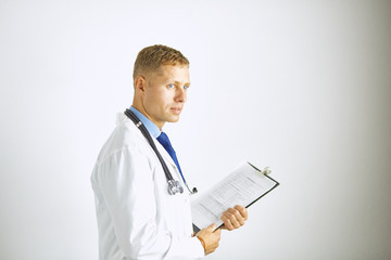 Young confident doctor in a white coat with a stethoscope