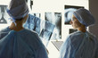 © lenetsnikolai - Two female women medical doctors looking at x-rays in a hospita