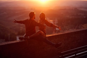 Wall Mural - Lovers. romantic at sunset. man and woman smiling and enjoying together