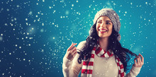 Happy Young Woman In Winter Clothes In A Snowy Night