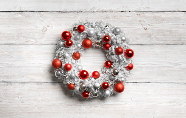 Christmas Wreath on White Wooden Background, Hanging Decoration on Holiday Wood Planks Wall