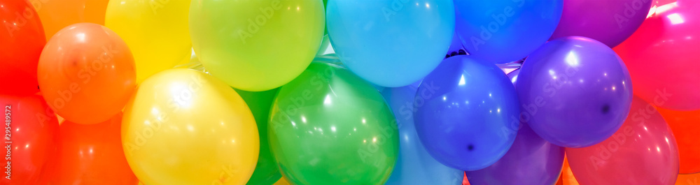 Wide celebration banner background with rainbow multicolored balloons. - obrazy, fototapety, plakaty 