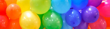 Wide Celebration Banner Background With Rainbow Multicolored Balloons.