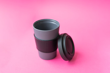 coffee mug made of gray bamboo material on a pink flat lay