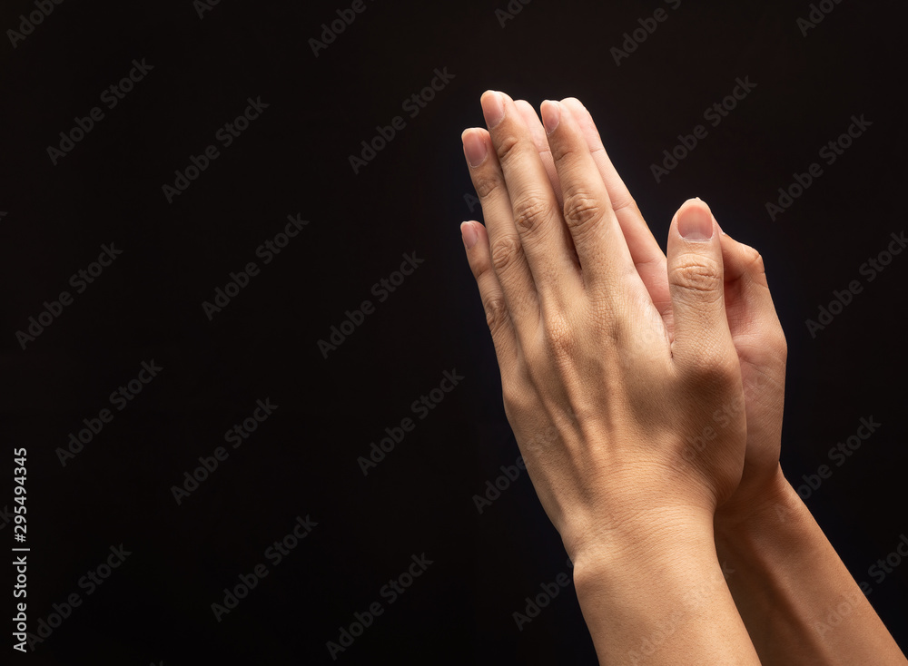 Praying hands in the dark background with faith in religion and belief ...