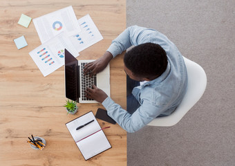 Poster - Top view of black employee working on laptop in office