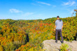 © Muskoka - Man on cliff overlooking wilderness