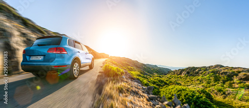 Fotomural SUV car in spain mountain landscape road at sunset