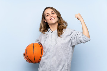 Wall Mural - Young blonde woman with ball of basketball