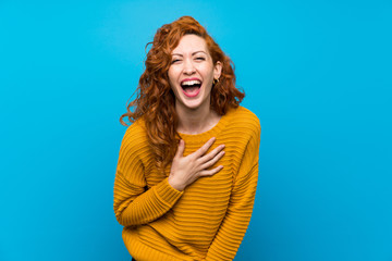 Redhead woman with yellow sweater smiling a lot