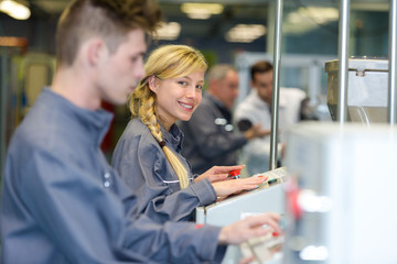 smily female worker wearing operating machine