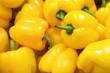 Fresh yellow peppers, closeup background.