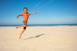 Boy jump and dance on the sand sea beach