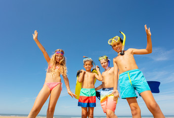 Wall Mural - Group of four kids together portrait on the beach