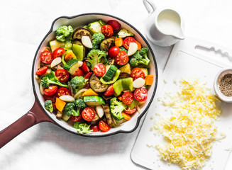 Vegetarian casserole ratatouille, baked in a frying pan on a light background, top view