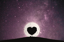 Heart Shape Of Big Tree And Alone Man Sitting On A Mountain Under Love Tree Landscape With Fantasy Night Sky And Full Moon. Stunning Views At Lonely Nights.