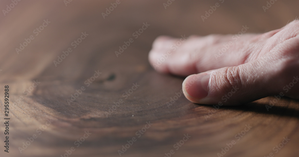 man hand touch oil finished black walnut wood surface - obrazy, fototapety, plakaty 