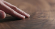 © GCapture - man hand touch oil finished black walnut wood surface