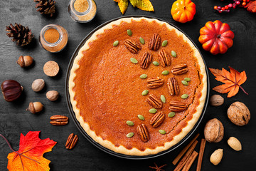 Wall Mural - Festive Homemade Pumpkin Pie decorated with pecan nuts and pumpkin seeds.