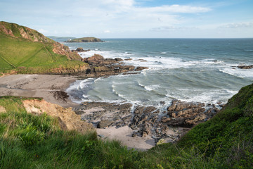 Wall Mural - Stunning late evening Spring landscape image of Ayrmer Cove on Devon coastline in England